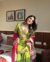 Vibrant lime green traditional outfit with pink and gold accents.
