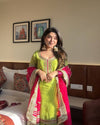 Vibrant lime green traditional outfit with pink and gold accents.