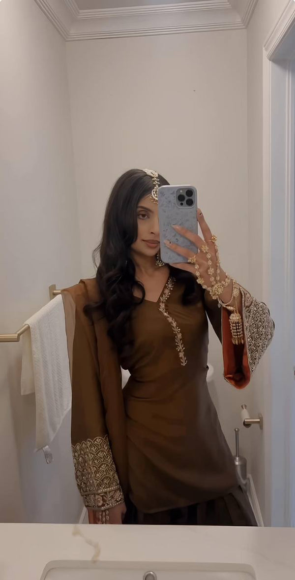 Elegant Brown Traditional Outfit with Orange Dupatta, Embellished Sleeves, and Gold Jewelry Ensemble
