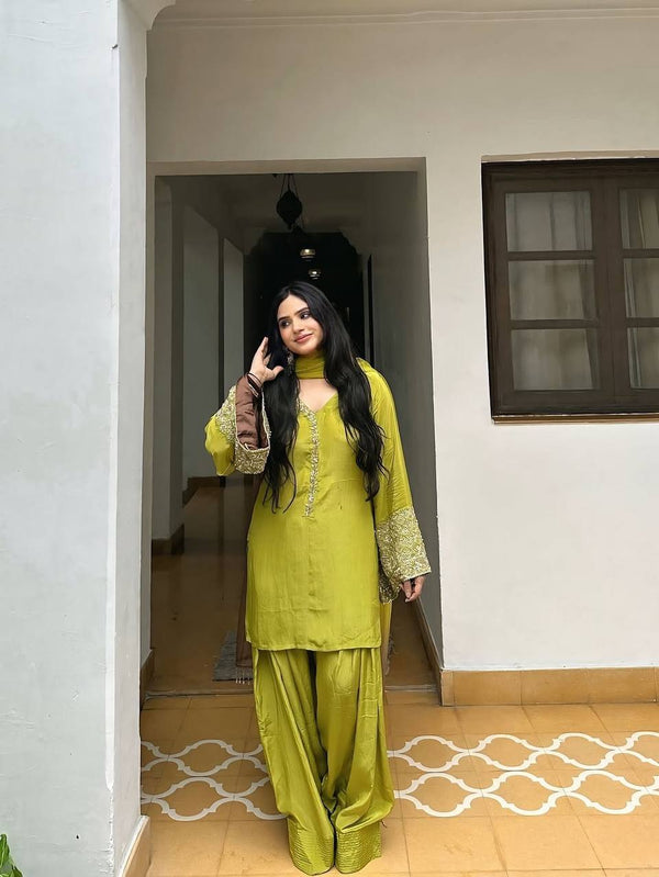 Elegant Brown Traditional Outfit with Orange Dupatta, Embellished Sleeves, and Gold Jewelry Ensemble
