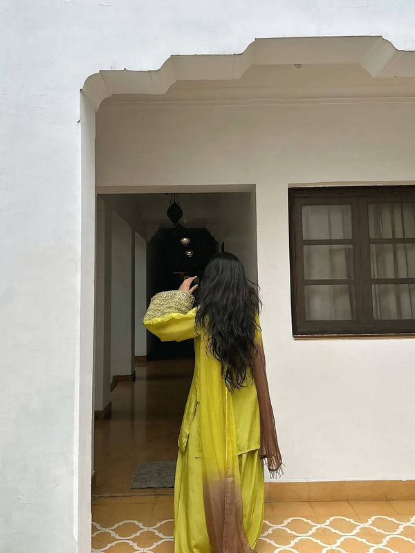 Elegant Brown Traditional Outfit with Orange Dupatta, Embellished Sleeves, and Gold Jewelry Ensemble